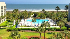 A resort with a pool, palm trees, and a beach view. - Shorewood, Unit 530 Penthouse condo in Hilton Head with ocean views (Hilton Head)