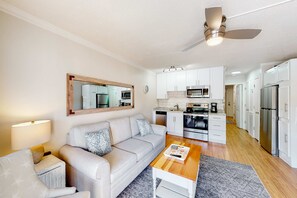 A modern kitchen with white cabinets, a microwave, and a stove. - Inviting condo with pool, tennis, balcony, central AC, & WD (Hilton Head)