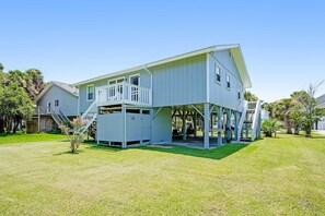 A two-story house with a covered porch and a small garden. - Dreamy Coastal Oasis W/ Large Deck, Fast WiFi, Beach Access Nearby & Central AC (Edisto Beach)