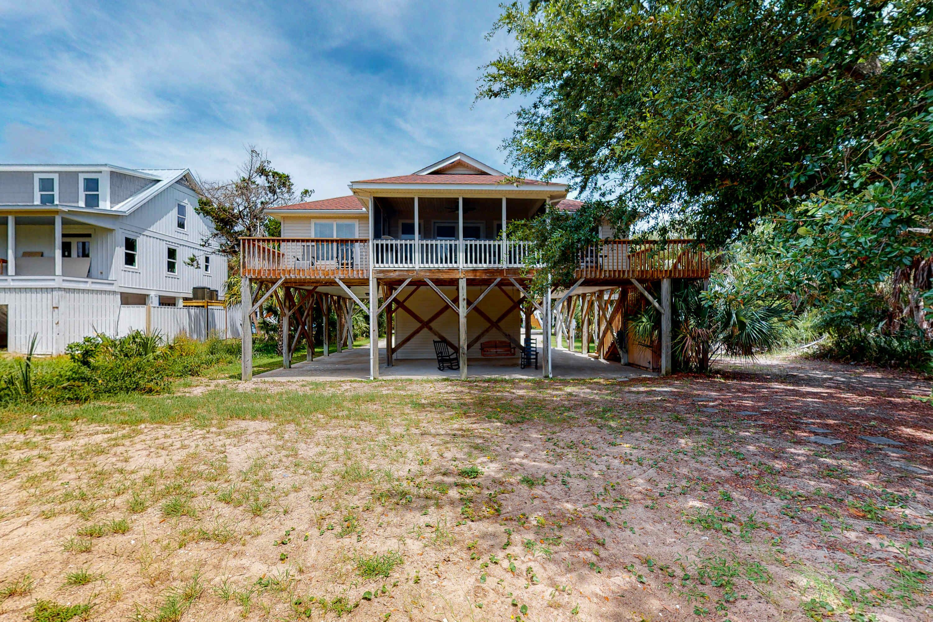 A two-story house with a balcony and a wooden deck.
