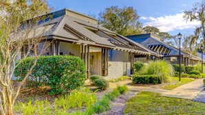 A row of modern houses with sloped roofs, a pathway, and well-maintained landscaping. - Beautifully remodeled villa with WiFi, inviting porch & balconies walk to beach (Hilton Head)