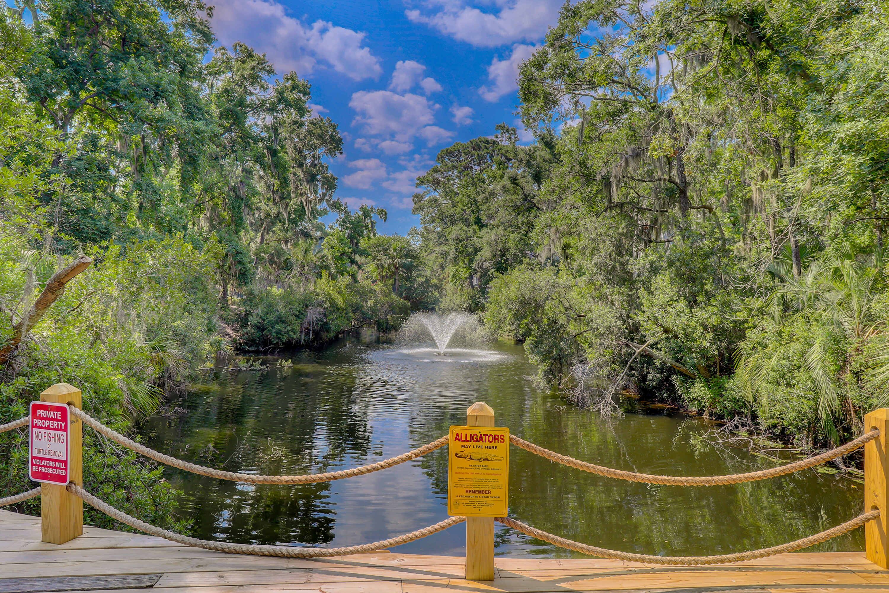 A private property with a no-fishing sign and an alligators may live here sign.