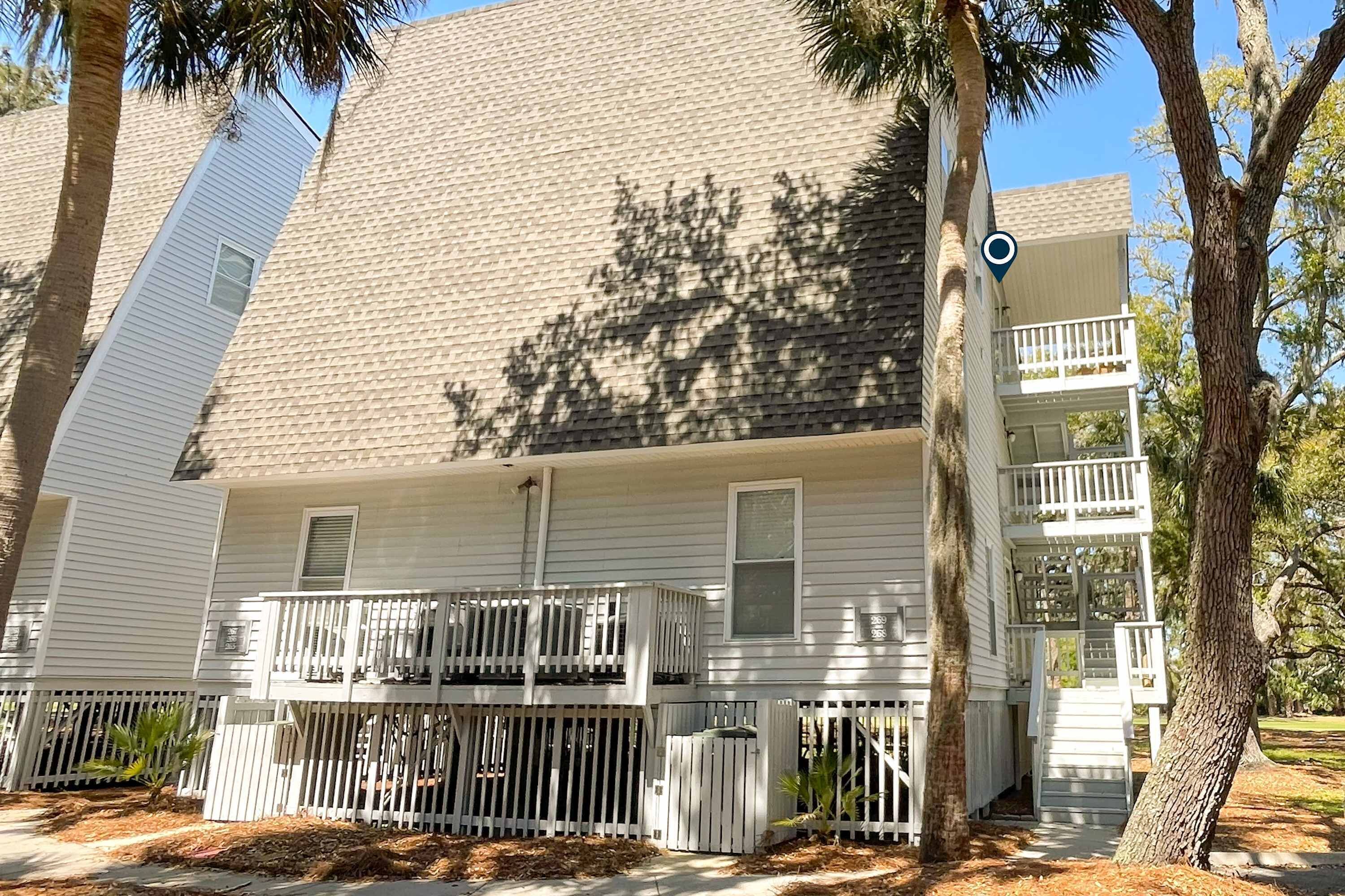 A two-story building with a balcony on the ground floor and a second-floor balcony.