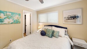 A bedroom with a bed, a ceiling fan, a window with blinds, and a door. - The Hedges D1 Condo in Hilton Head with pool & tennis, walk to the beach (Hilton Head)