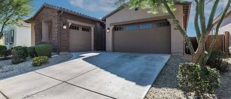 A residential property with a garage, a driveway, and a well-maintained lawn.