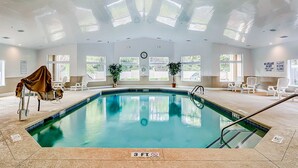 An indoor swimming pool with a 3 FT depth marker, white chairs, and potted plants. - 2nd floor Coastal Condo, pool, tennis and close to beach (Hilton Head)