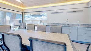A modern kitchen with a large island, built-in appliances, and a view of the outside. - Spacious, Renovated House with Private Spa and Private Pool (Hilton Head)