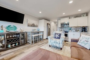 A modern kitchen with white cabinets, a microwave, and a coffee machine. - 3rd floor Villa, pool, tennis pickleball, bike rentals & close to beach (Hilton Head)