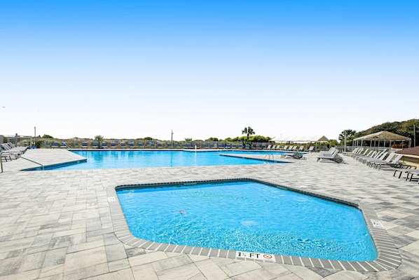 A swimming pool with multiple lanes, sun loungers, and a tiled deck. - 3rd-floor snowbird-friendly condo with pool, tennis, volleyball, gym, & balcony (Hilton Head)