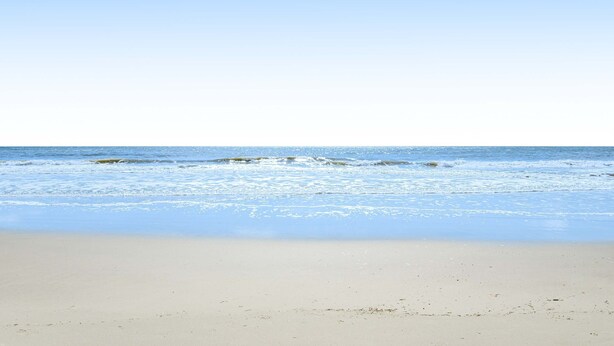 A beach with clear skies and calm waves. - Updated island Villa with two pools, tennis, & game room - walk to the beach (Hilton Head)