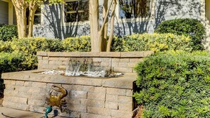 A landscaped garden with a water feature, stone steps, and a crab sculpture. - Updated island Villa with two pools, tennis, & game room - walk to the beach (Hilton Head)