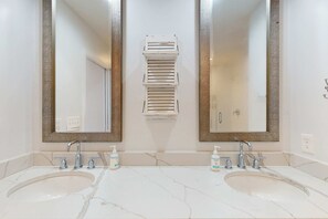 A bathroom with two sinks, two mirrors, and a towel rack. - Dog-friendly, golf-course adjacent townhouse w a wet bar, patio, & shared pool (Hilton Head)