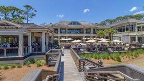 Un hôtel situé sur la côte, doté d’une terrasse pour prendre les repas en plein air, d’une promenade en bois et offrant une vue sur la plage.