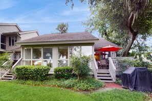A house with a covered porch, a staircase, and a lawn. - Villa with saltwater pool, golf, firepit, hot tub, & private beach access (Hilton Head)