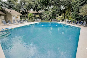 A swimming pool with lounge chairs and a lifeguard stand. - Villa with saltwater pool, golf, firepit, hot tub, & private beach access (Hilton Head)