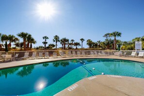 A clear swimming pool with lounge chairs and palm trees. - Beach condo with Ocean Views, outdoor pool & balcony - Walk to Beach (Hilton Head)