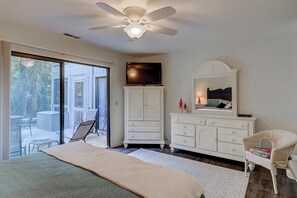A bedroom with a bed, a television, a dresser, and a chair. - Comfortable Townhome with WiFi, Screened Porch, Shared Pool and Tennis Court (Hilton Head Island)