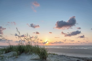 A beach with sand dunes and grasses, a sunset, and a calm sea. - Second Floor Villa Near the Beach with Balcony Views of the Pool & Lagoon (Hilton Head)