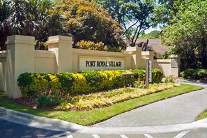 A sign for Port Royal Village with a landscaped entrance and a paved driveway. - Family-friendly condo near the beach with balcony, central AC, & shared pool (Hilton Head)
