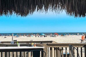 A beachside restaurant with outdoor seating, a view of the beach, and umbrellas. - 4th-floor villa with balcony, beach access, outdoor pool, & grills (Hilton Head)
