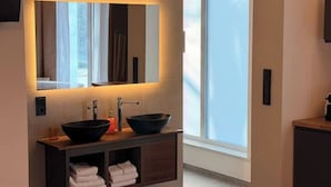 A modern bathroom with a large mirror, two sinks, and a window. - Villa Weitmar: Private spa - sauna and designer bathtub (Bochum)