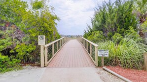 A wooden boardwalk leading through a natural area with dense vegetation on both sides. - Hilton Head Resort Villa with AC, pool, hot tub, tennis - near beach & golf (Hilton Head)