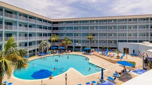 A hotel with a swimming pool, multiple balconies, and outdoor seating areas. - Hilton Head Resort Villa with AC, pool, hot tub, tennis - near beach & golf (Hilton Head)