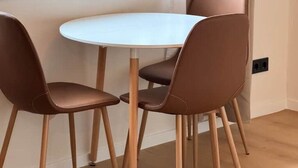 A dining area with a round table and four chairs.