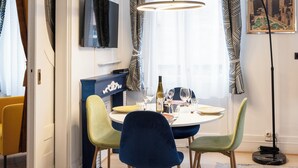 A dining area with a round table, chairs, and a pendant light. - La Pépite Place Mondon pour voir le PAPE du balcon (Metz)