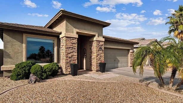 A residential house with a garage, a stone entrance, and a gravel driveway. - Little Peace and Quiet out on Little Leaf (San Tan Valley)