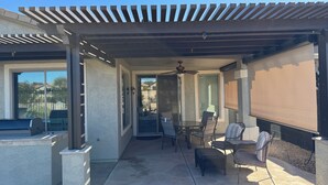 A covered patio area with a ceiling fan, outdoor furniture, and a view of the street. - Little Peace and Quiet out on Little Leaf (San Tan Valley)