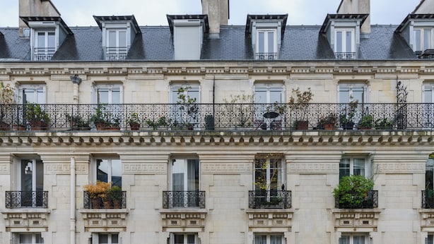 A multi-story building with balconies, windows with shutters, and decorative iron railings. - Paris Center St Claude residence (Paris)