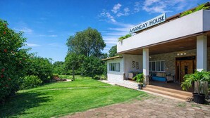 A modern house with a sign reading 'AMANCAY HOUSE.'