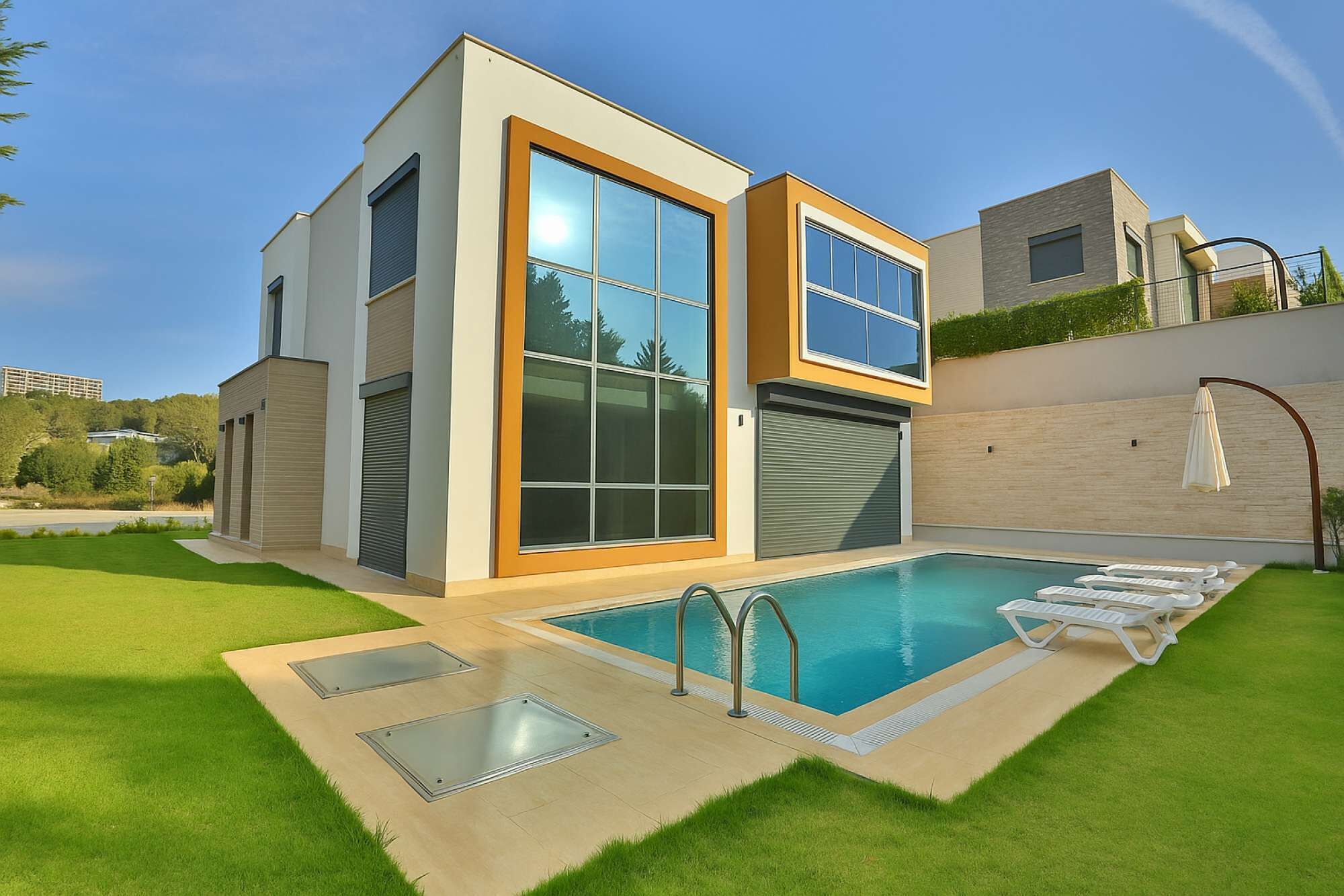 A modern two-story house with a swimming pool, large windows, and a well-maintained lawn.
