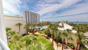 A hotel with a pool, palm trees, and a view of the ocean. - Family Fun Condo Near Private Beach Silver Dunes 48 (Destin)
