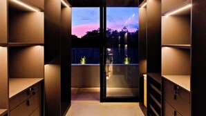 A modern interior with built-in shelving, a glass door leading to an outdoor area, and a view of the sky. - Luxury Mansion VILLA MARIA (brand new) (Tibau do Sul- RN)
