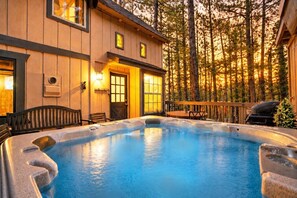 A hot tub in a wooden cabin with a deck, surrounded by trees. - Iris Haus, w/ Hot Tub, Forest Views and Game Room (Big Bear Lake)