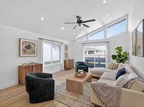 A spacious living room with a sofa, armchair, and coffee table. - Outrigger Beach Retreat w/ Private Path & Firepit (Oxnard)