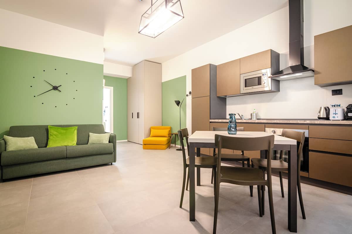 A modern kitchen with a microwave, stove, and cabinets.