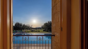 A balcony with a view of a swimming pool and a golf course. - Villa 151 Luxury Villa - Private Pool and Tennis Court (Kouklia)