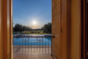 A balcony with a view of a swimming pool and a golf course. - Villa 151 Luxury Villa - Private Pool and Tennis Court (Kouklia)