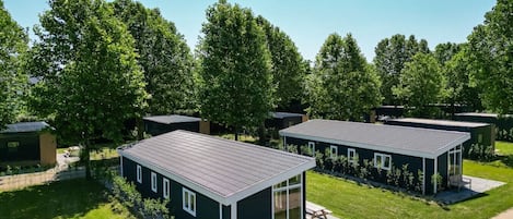 A modern residential area with detached houses featuring large windows and flat roofs.