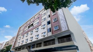 A multi-story residential building with a modern design, featuring balconies and air conditioning units. - Townhouse Kukatpally Formerly SV Royal (Hyderabad)