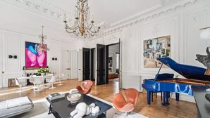 A spacious living room with a grand piano, modern furniture, and a large painting on the wall. - A 300m² Estate of Art, Elegance & Architectural Majesty:Blvd.de la Tour-Maubourg (Paris)