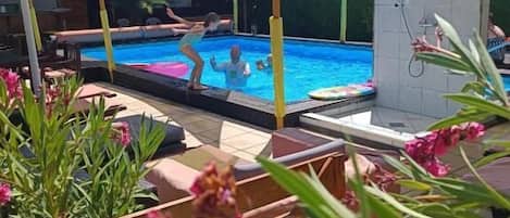 Seasonal outdoor pool, open 9:00 AM to 7:30 PM, pool umbrellas