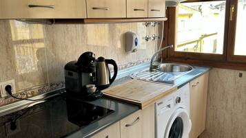 Penthouse, balcón, vista a la ciudad | Cocina privada