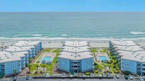 A hotel with multiple buildings, a swimming pool, and a beach view. - Oceanfront•Steps to beach•Pool view•Sleeps 6 (Myrtle beach)