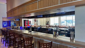 A bar area with a counter, seating, and vending machines. - 3BR Townhome at Regal Oaks Near Disney (Kissimmee)