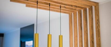 A wooden ceiling structure with three pendant lights.