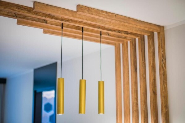 A wooden ceiling structure with three pendant lights.